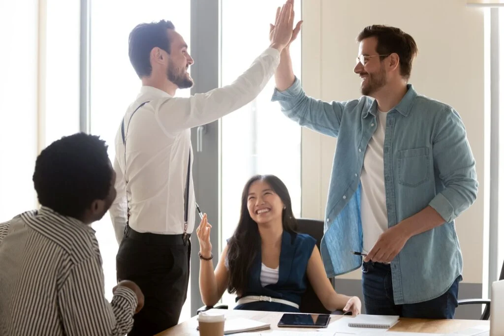 Excited motivated male team people give high five at diverse group meeting celebrate shared win express respect thank for help support in teamwork, happy business men with work group rejoice success